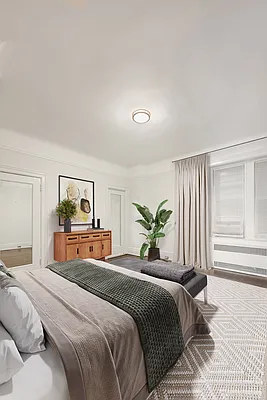 26 East 63rd Street, Unit 5F Manhattan, NY 10065 - Photo 2 of 5 a bedroom with a large bed and a window