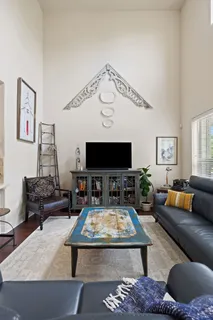a living room with furniture or couch and a potted plant