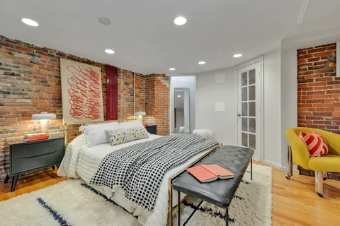 a bedroom with a bed a table and chairs