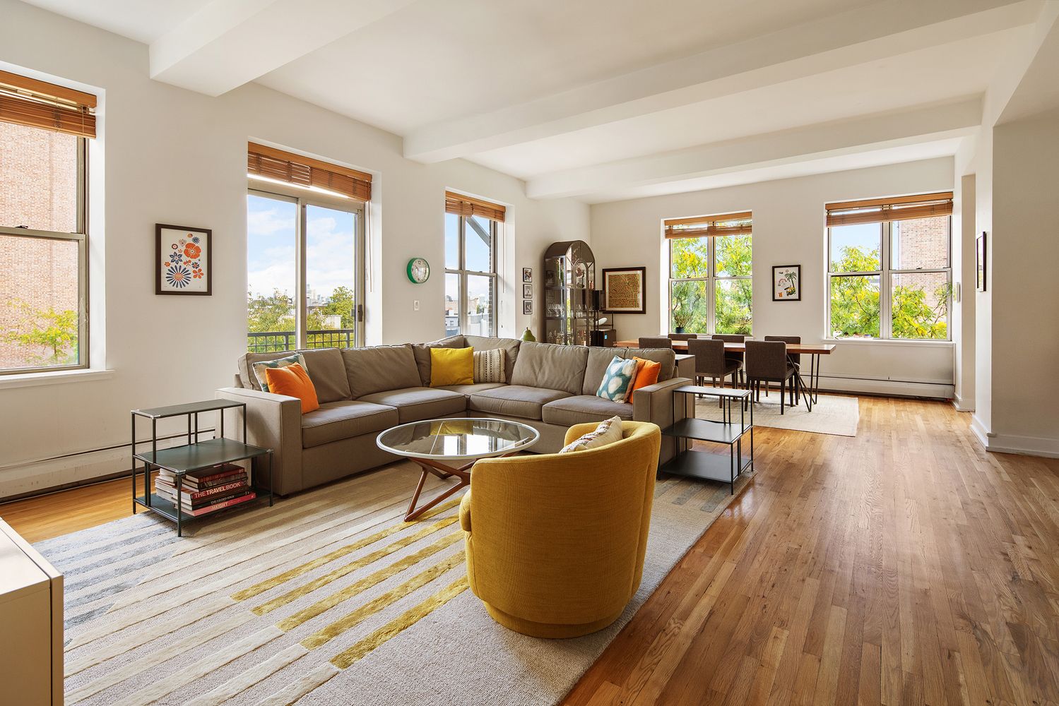 a living room with furniture and wooden floor