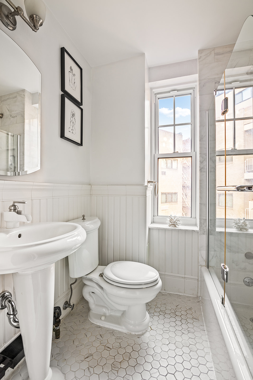 302 West 12th Street, Unit 5G Manhattan, NY 10014 - Photo 10 of 18 a bathroom with a sink toilet and shower