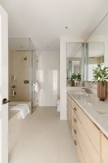 a bathroom with a shower sink and mirror