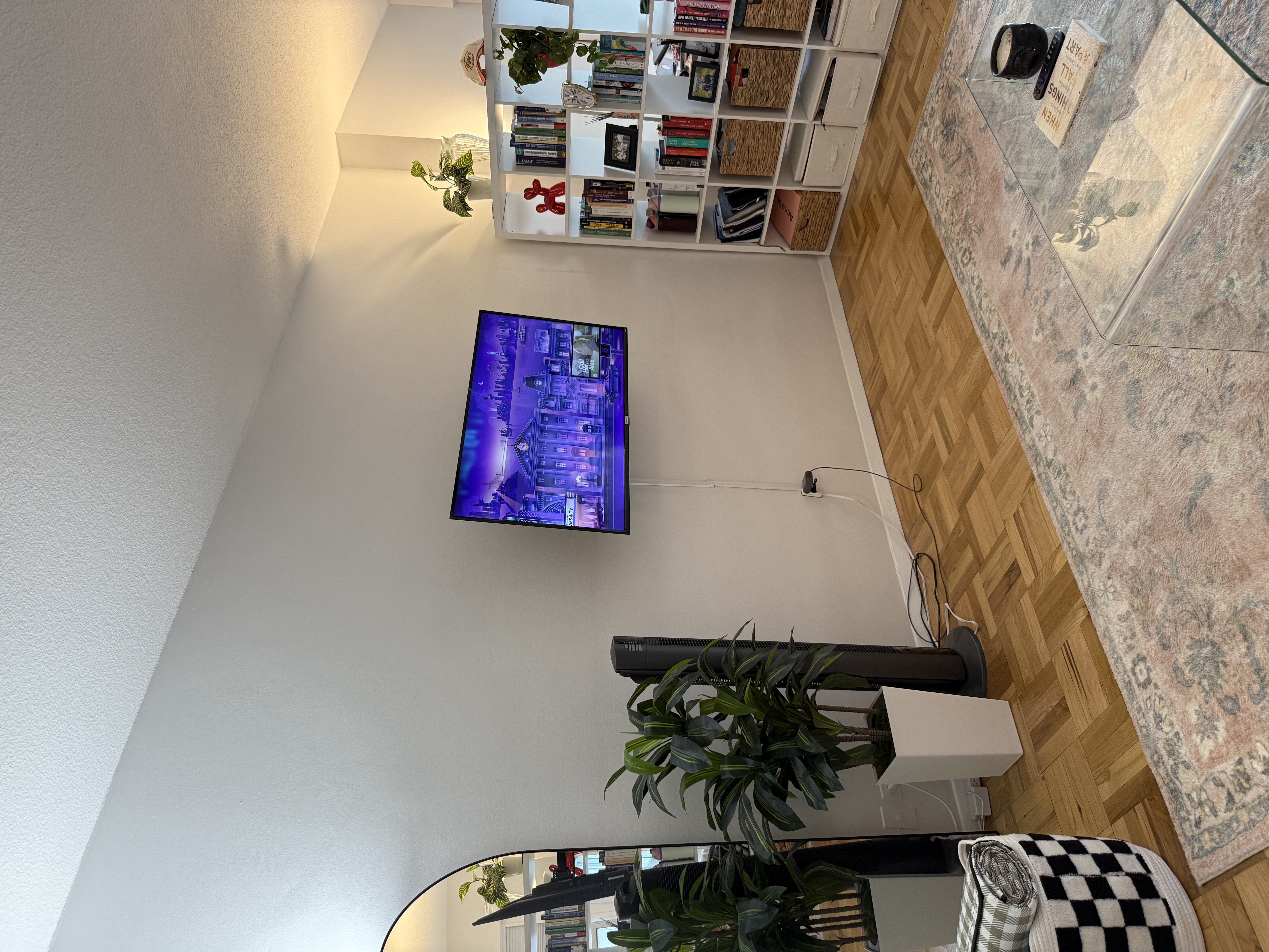 60 East 8th Street, Unit 9J Manhattan, NY 10003 - Photo 10 of 13 a view of a room with wooden floor and potted plant