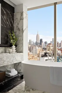 a bathroom with a large tub sink and mirror