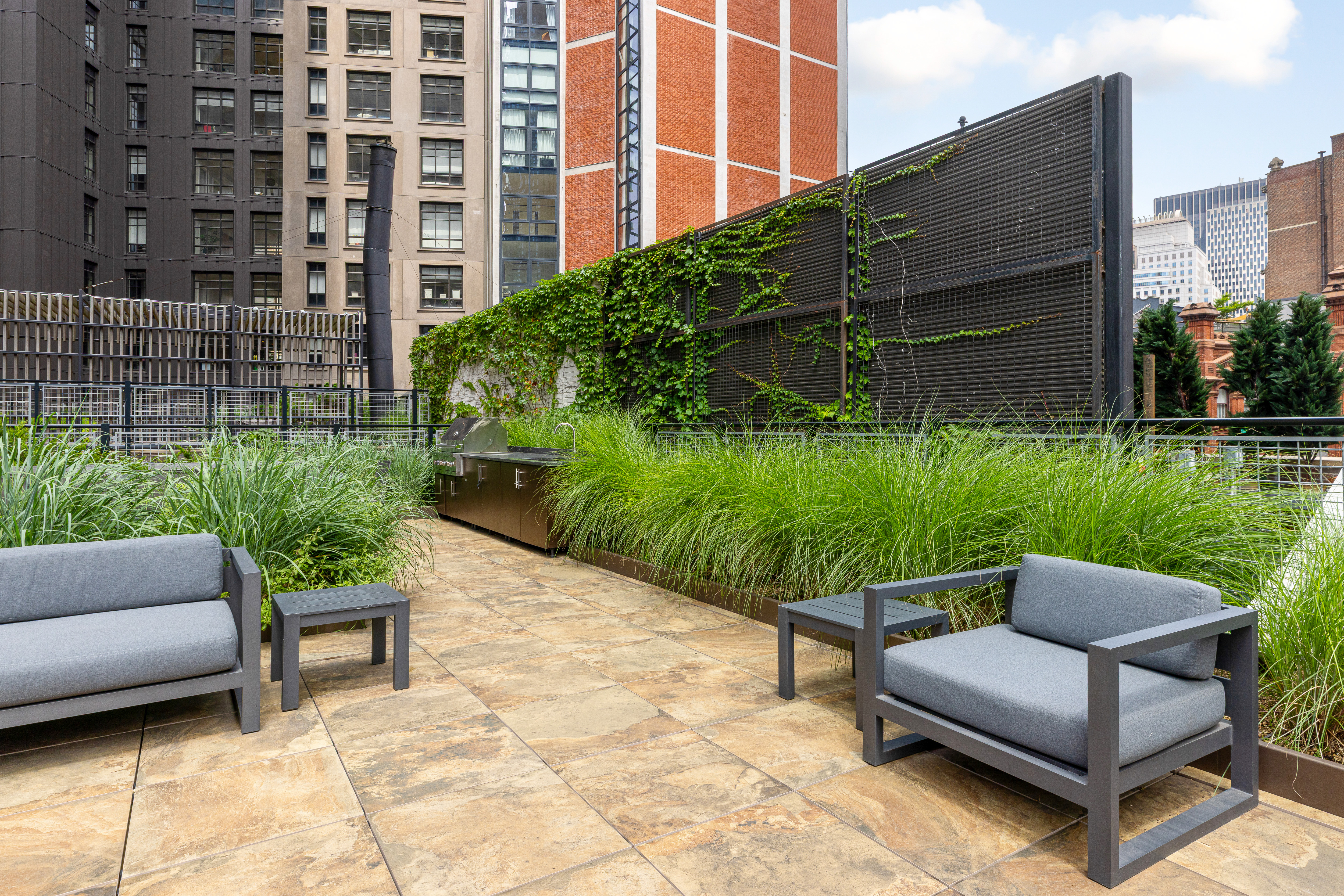 5 Beekman Street, Unit 43A Manhattan, NY 10038 - Photo 24 of 33 a view of a patio with couches and a table and chairs with plants