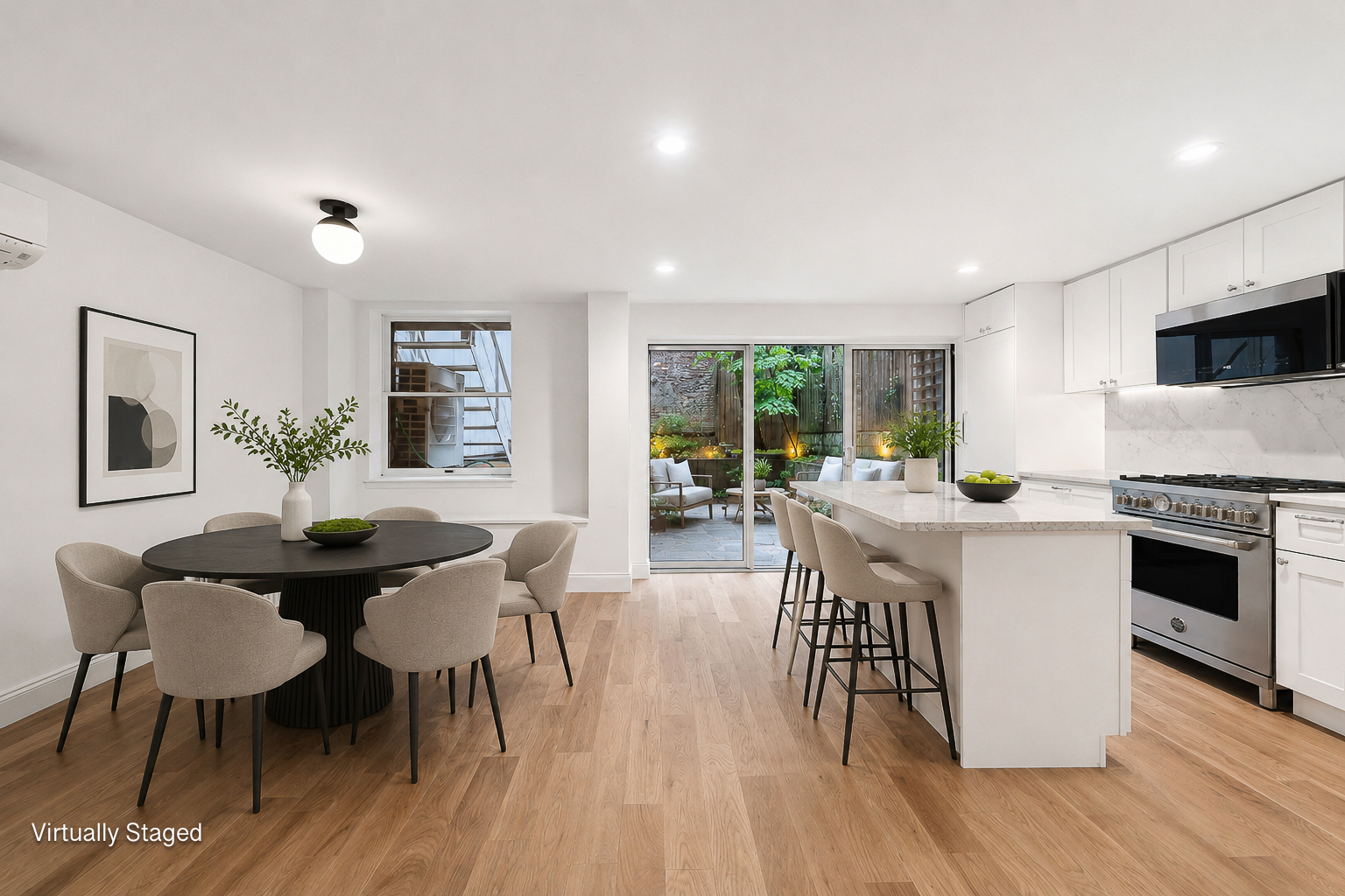 a kitchen with a table chairs stove and wooden floor