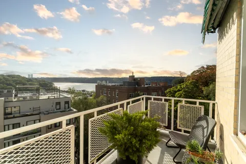 a view of a balcony with chairs
