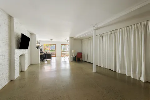 a view of a dining room with furniture and a window