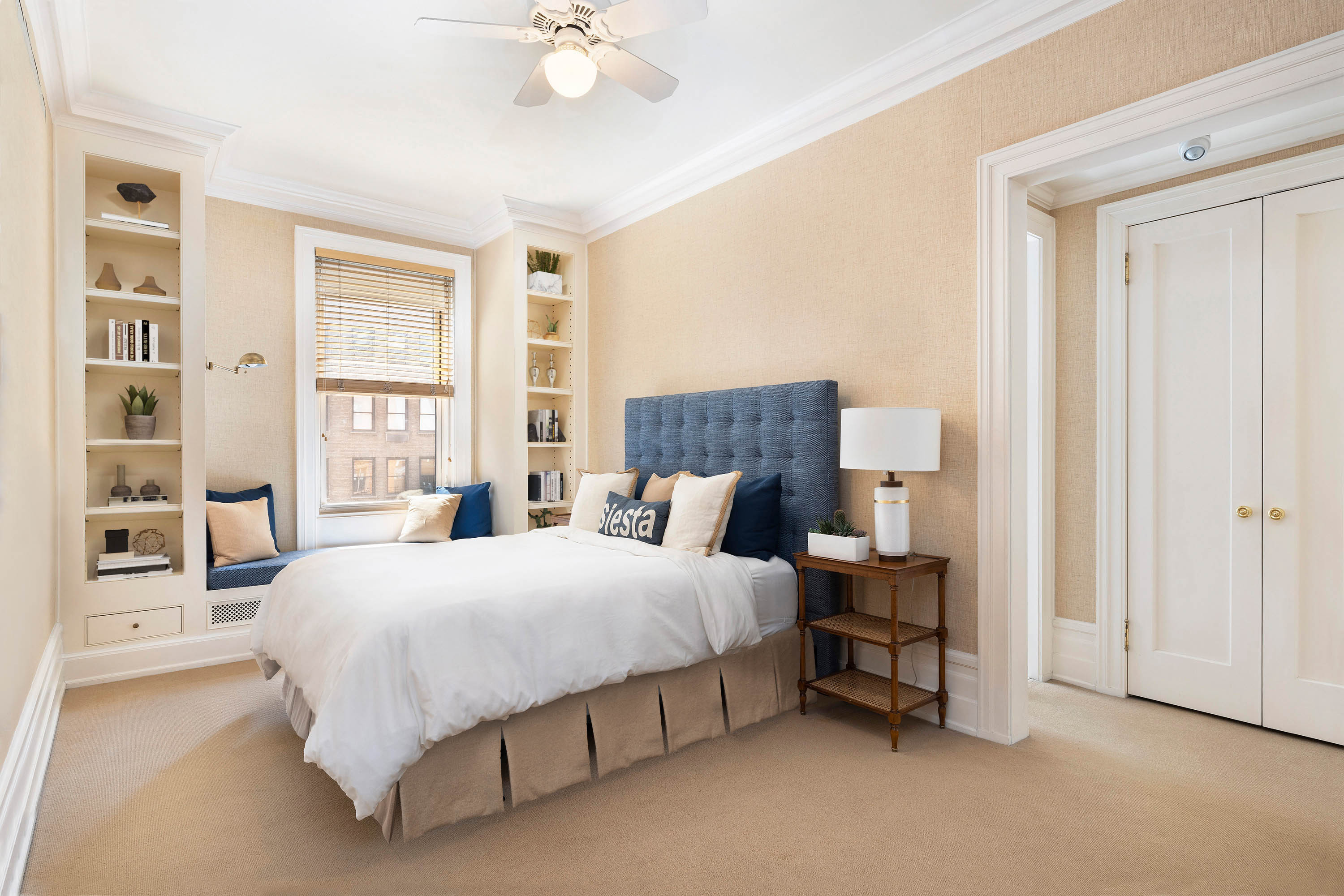 325 West End Avenue, Unit 6AB Manhattan, NY 10023 - Photo 14 of 22 a bedroom with a bed a table and painting on the wall