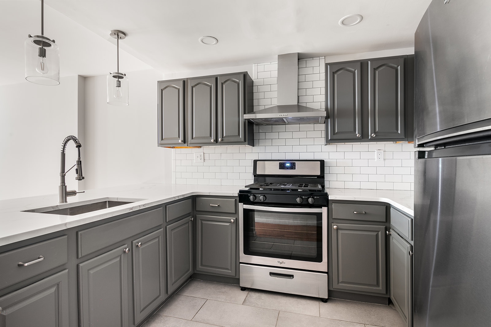 265 West 136th Street Manhattan, NY 10030 - Photo 10 of 14 a kitchen with a stove and a sink