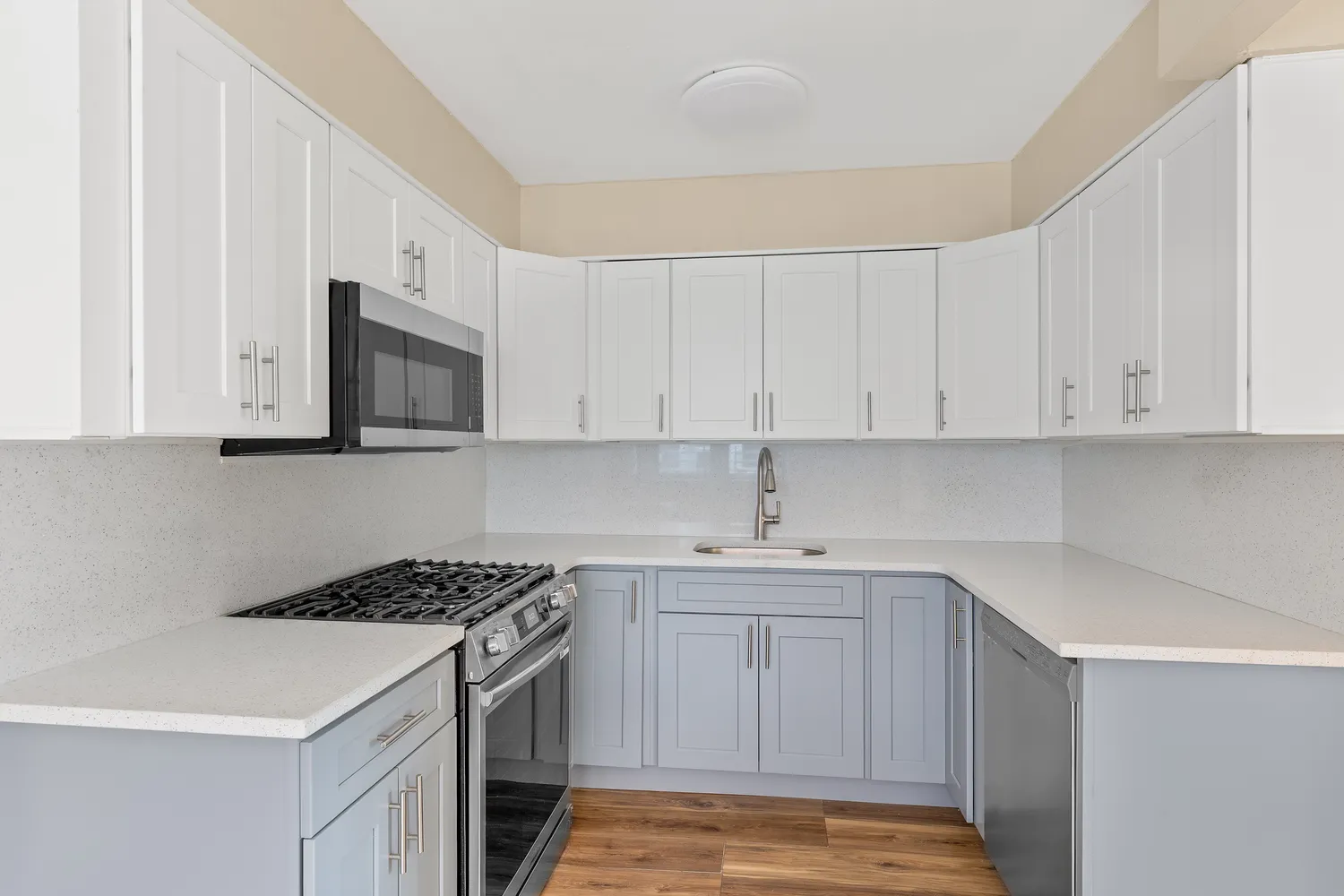 a kitchen with stainless steel appliances granite countertop a sink stove and microwave