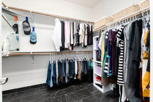 a bathroom with a sink double vanity granite tub shower and a mirror