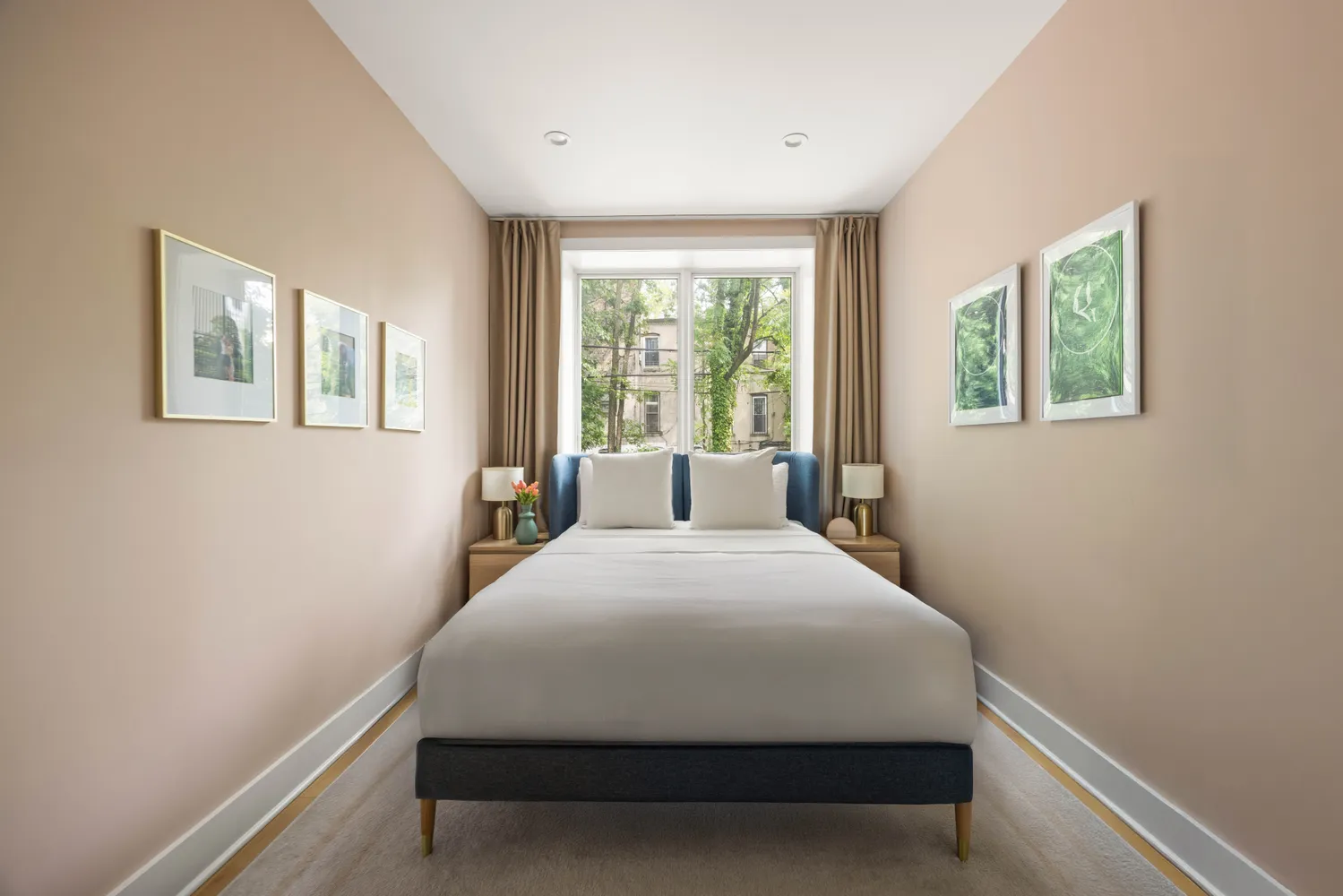 a large bed sitting in a bedroom next to a window