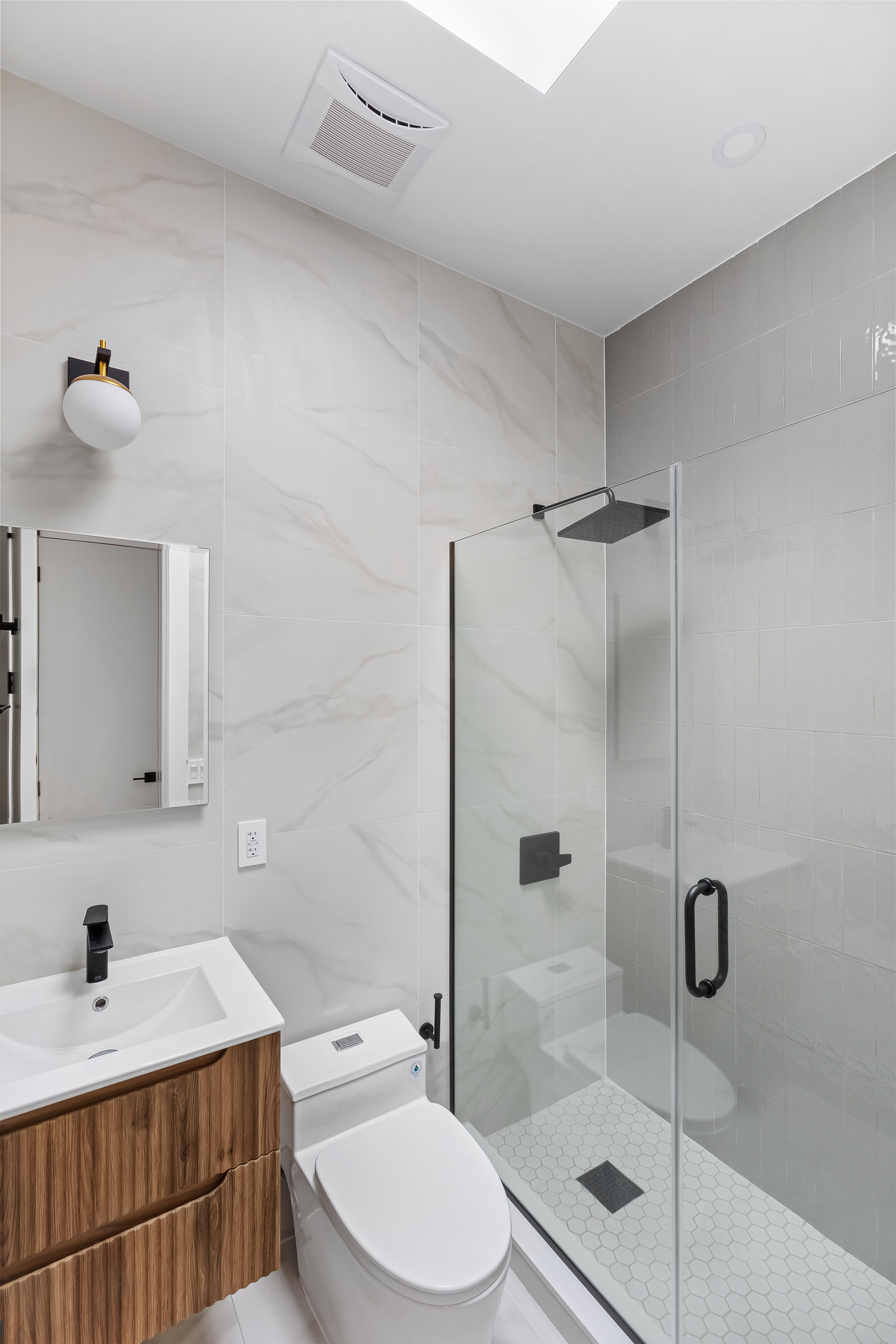 92 Jefferson Street, Unit 4 Brooklyn, NY 11206 - Photo 7 of 9 a bathroom with a sink toilet and shower