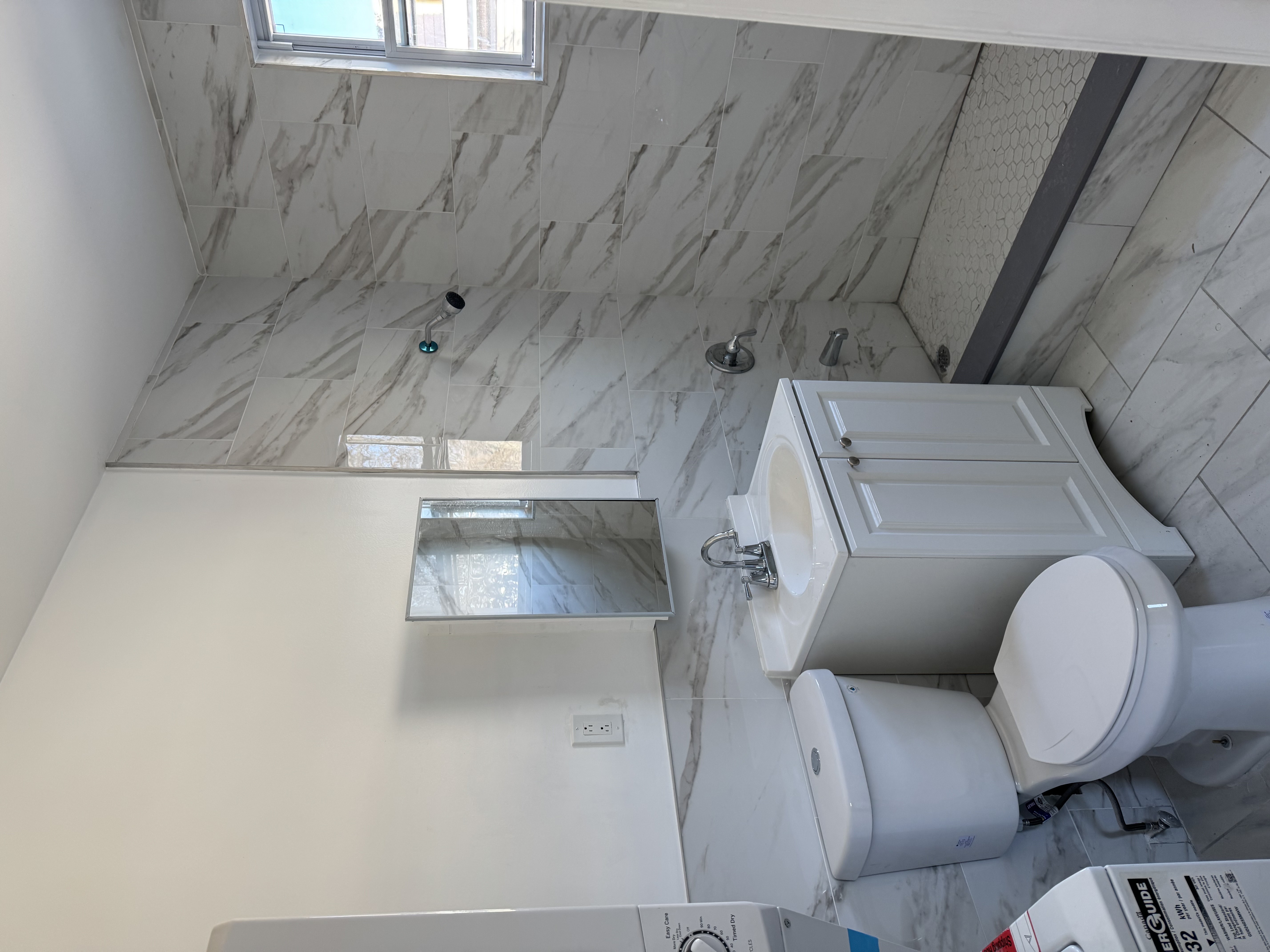 142 Driggs Avenue, Unit 3 Brooklyn, NY 11222 - Photo 5 of 8 a bathroom with a toilet a sink and mirror