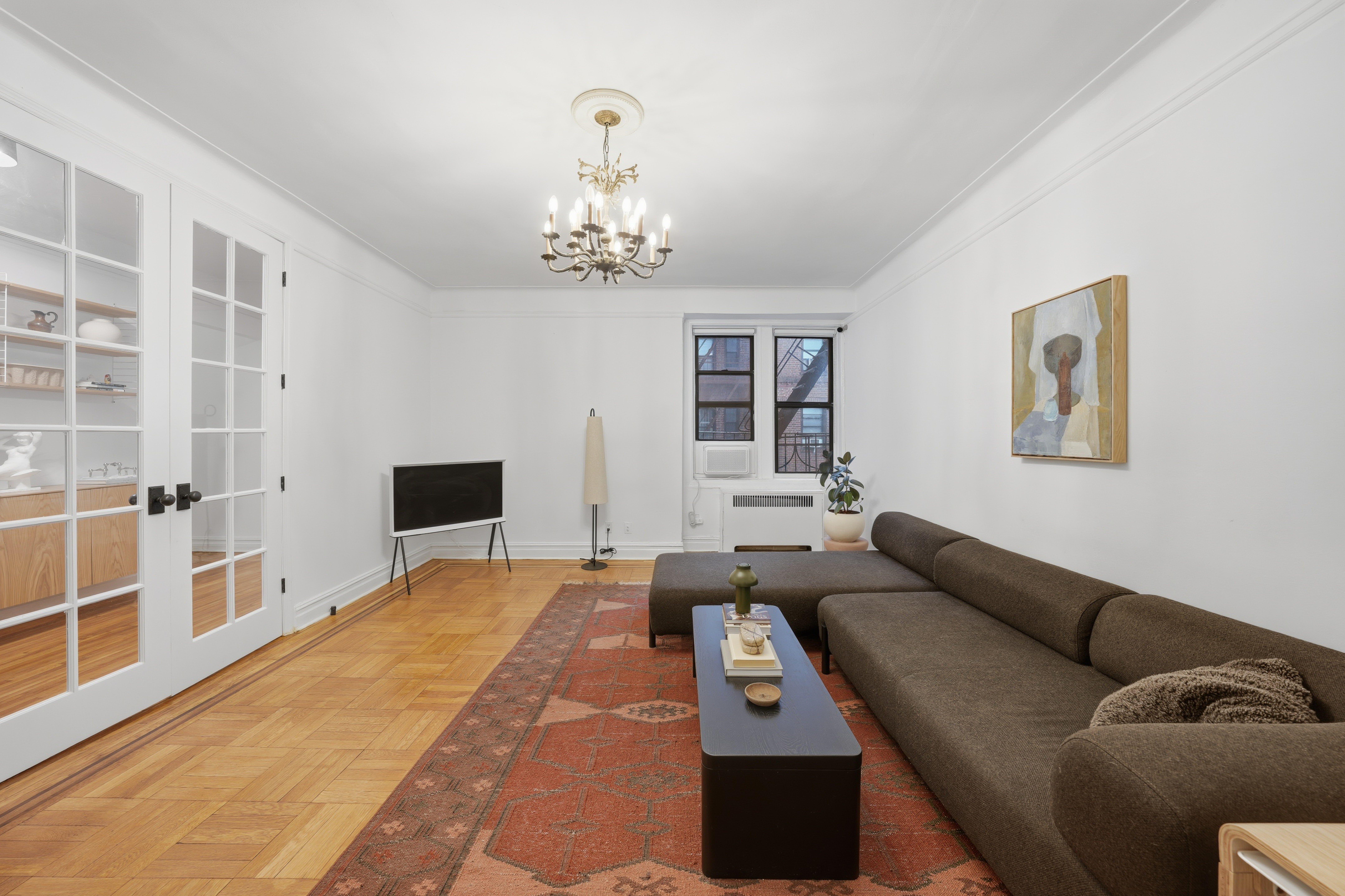 80 Avenue P, Unit D14 Brooklyn, NY 11204 - Photo 3 of 19 a living room with furniture a chandelier and a dining table