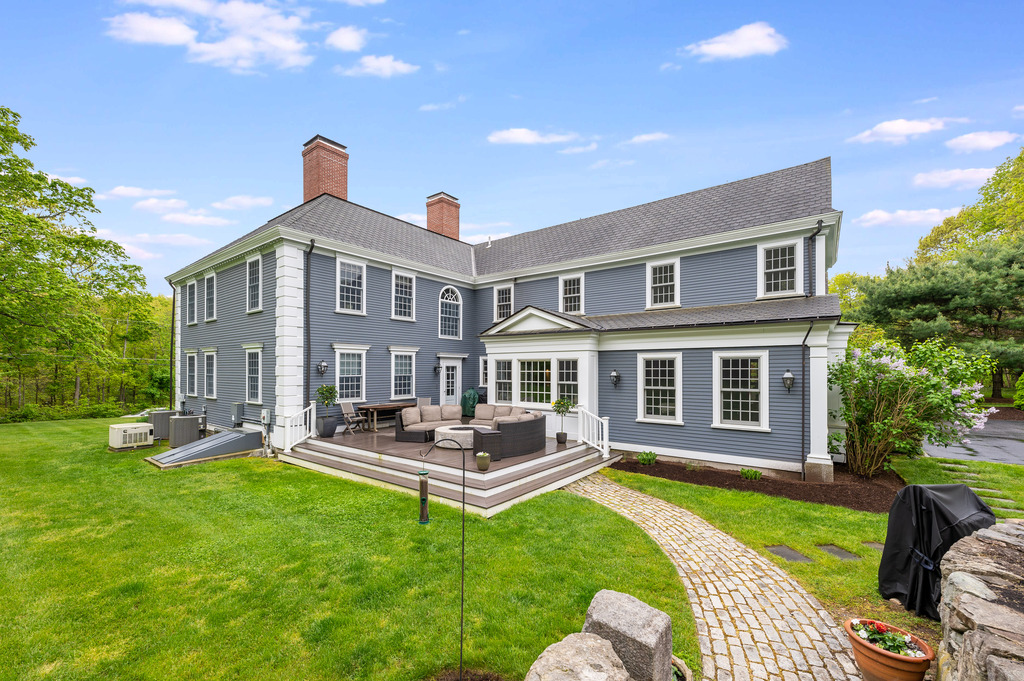 79 Pine Street Dover, MA 02030 - Photo 4 of 25 a front view of a house with garden and sitting area