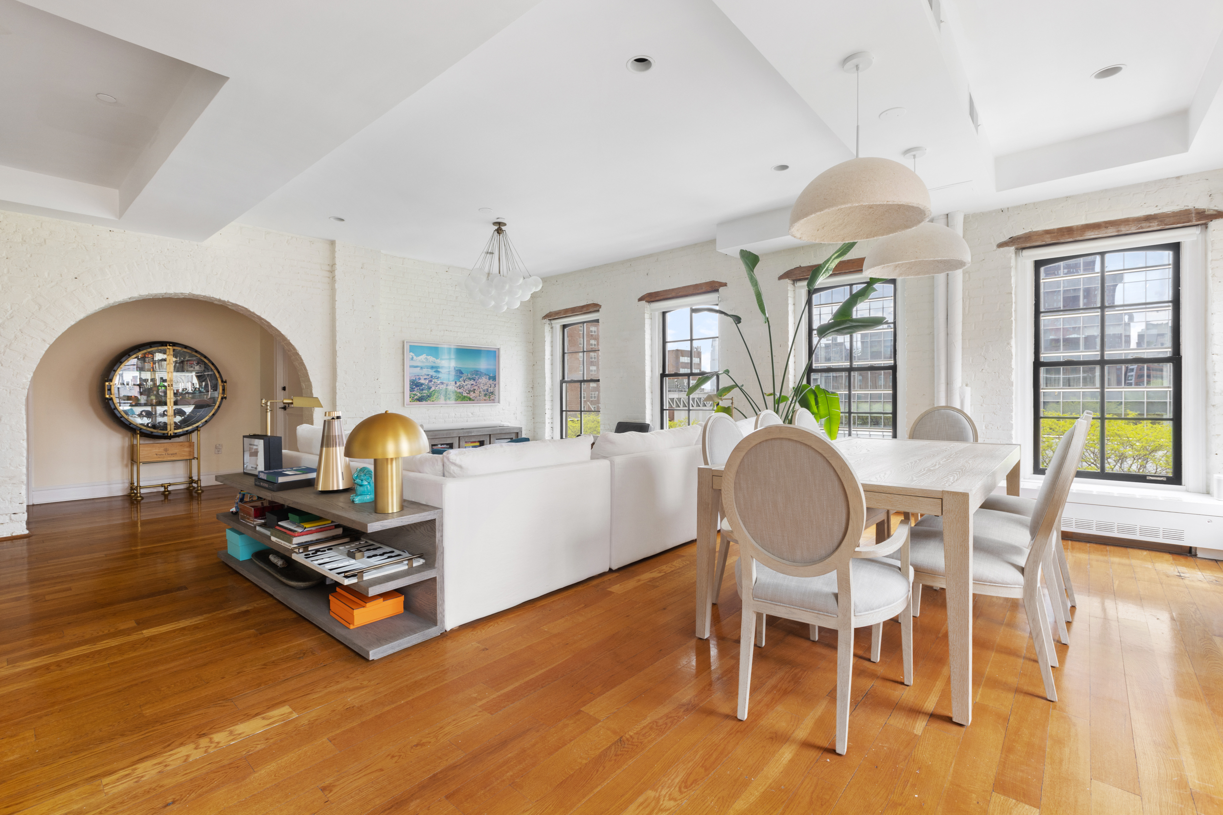 62 Beach Street, Unit 5E Manhattan, NY 10013 - Photo 5 of 15 a living room with furniture a rug and a chandelier