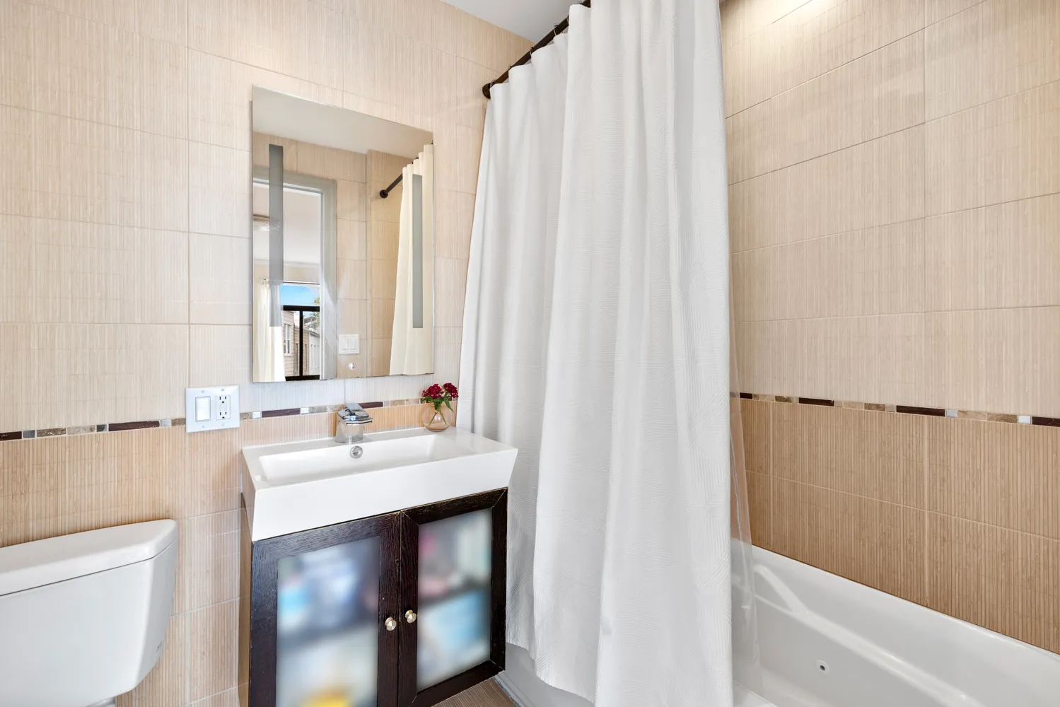 a en suite bathroom with a sink a toilet and a mirror