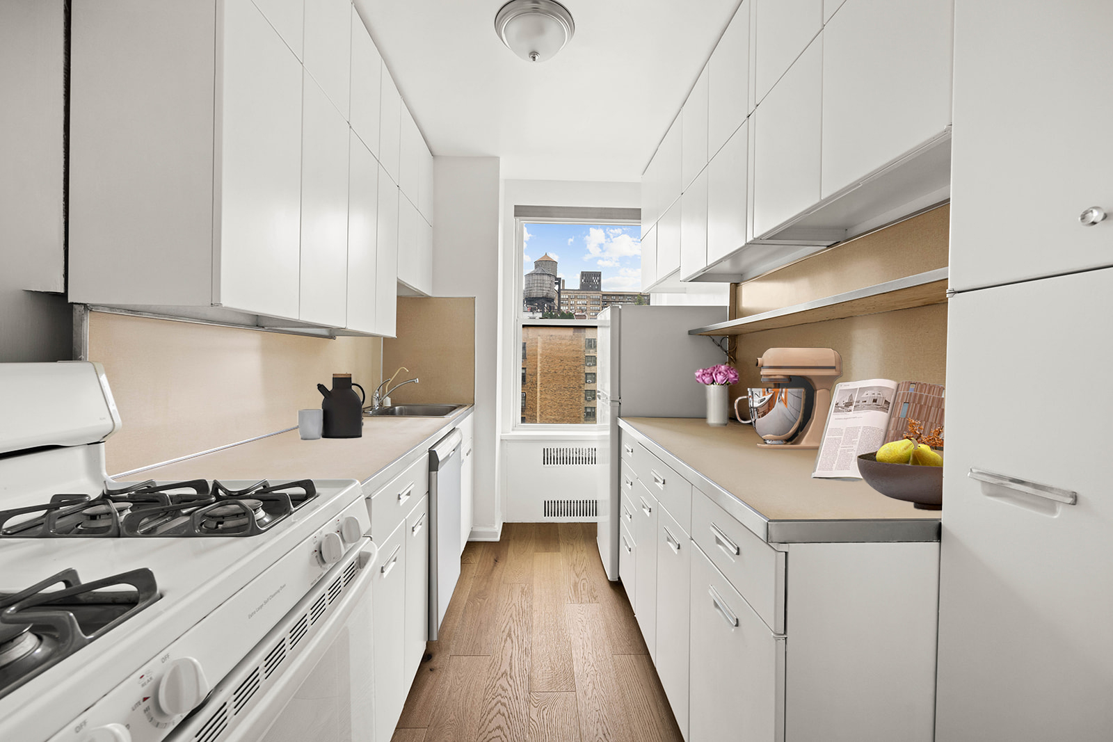 263 West End Avenue, Unit 13F Manhattan, NY 10023 - Photo 13 of 22 a kitchen with a sink a stove and cabinets