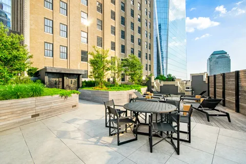 a view of a patio with a table and chairs and potted plants