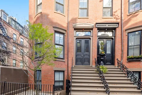 a view of a brick building with many windows