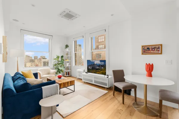 a living room with furniture and a wooden floor