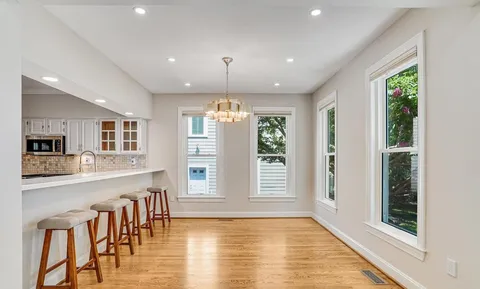 a view of a living room and kitchen floor with a window