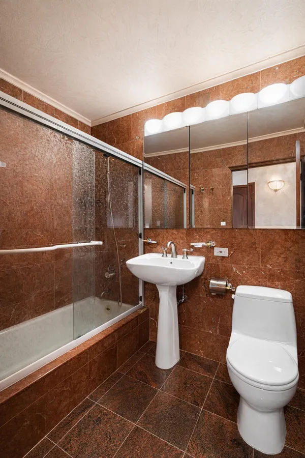 a bathroom with a sink toilet and shower