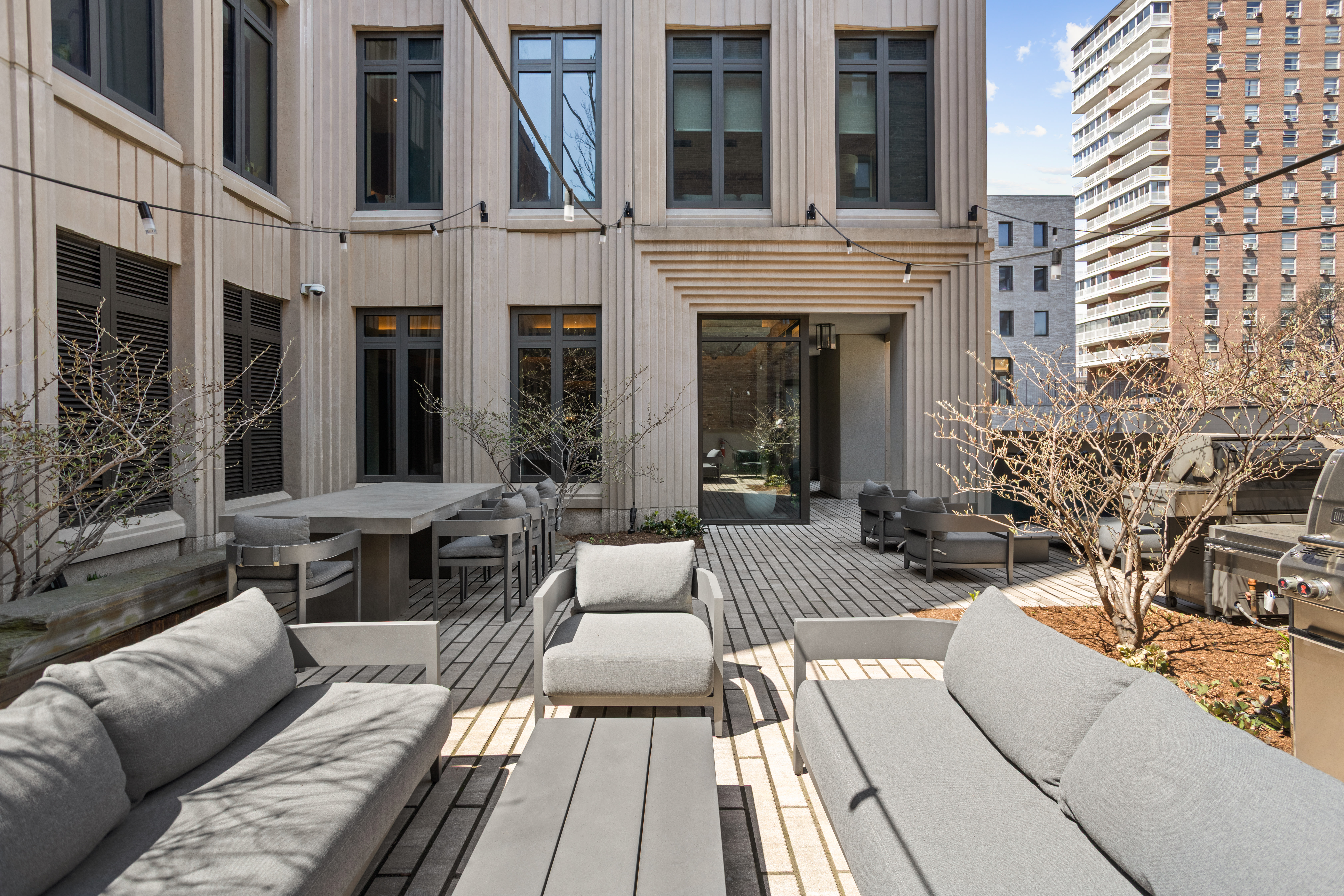 543 West 122nd Street, Unit PH31A Manhattan, NY 10027 - Photo 37 of 40 a view of a patio with couches table and chairs with wooden floor
