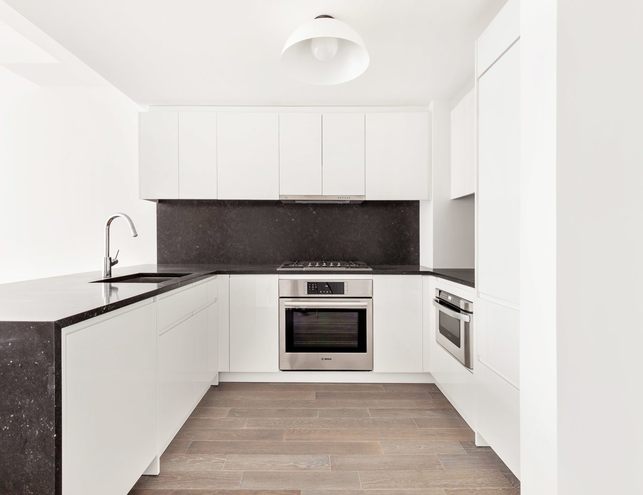 385 1st Avenue, Unit 14D Manhattan, NY 10010 - Photo 2 of 9 a kitchen with a stove and a microwave