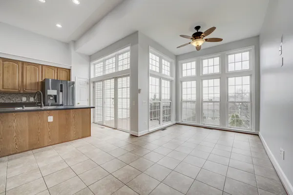 a view of kitchen with windows and ceiling fan