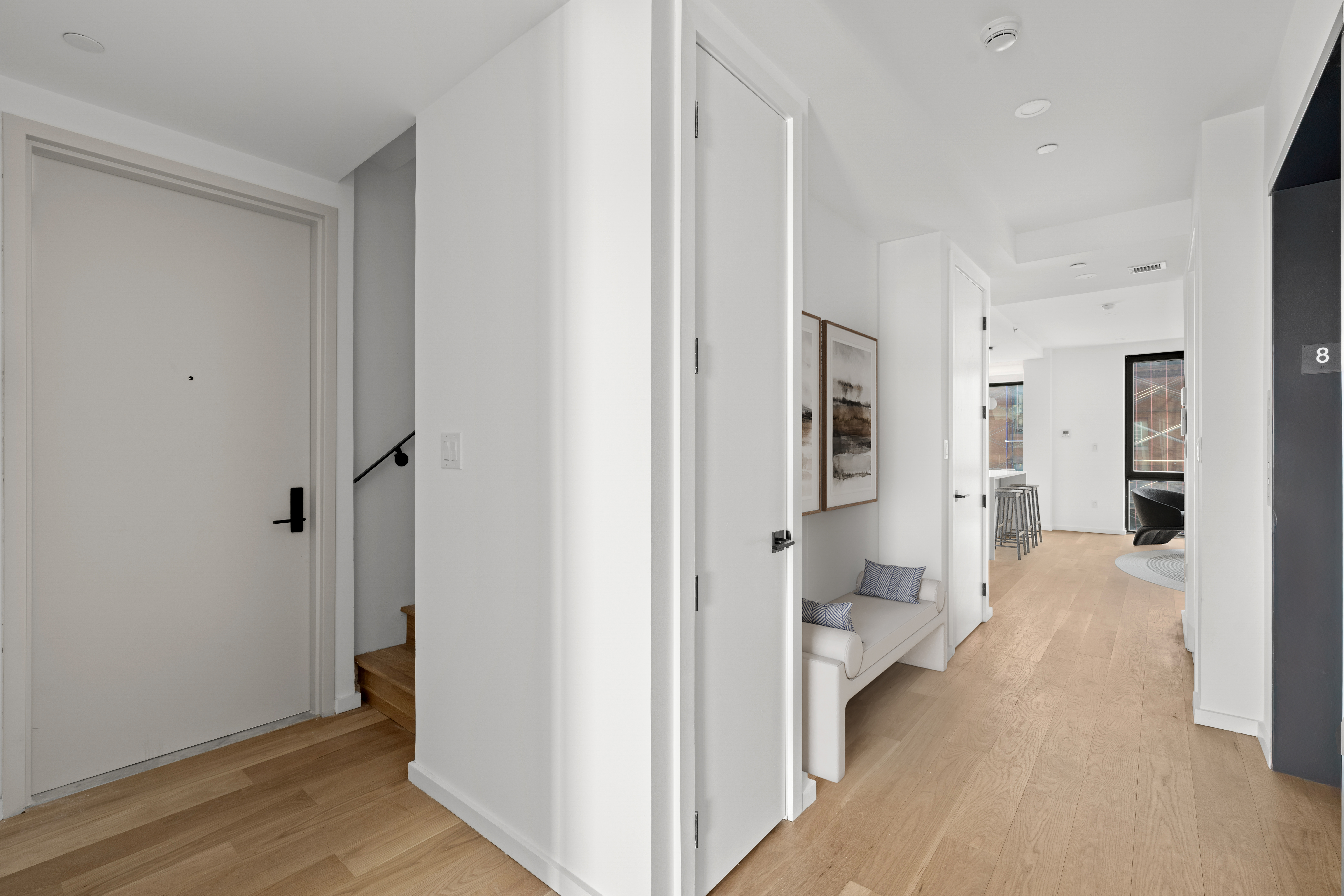 14-35 Broadway, Unit PH Queens, NY 11106 - Photo 19 of 24 a view of a bedroom with wooden floor and a bathroom