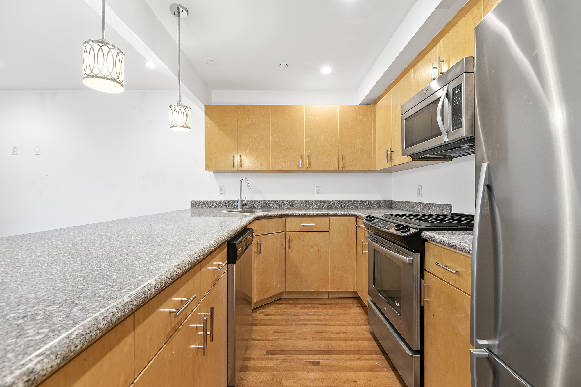 400 15th Street, Unit 2D Brooklyn, NY 11215 - Photo 4 of 8 a kitchen with stainless steel appliances granite countertop a stove a sink and a microwave