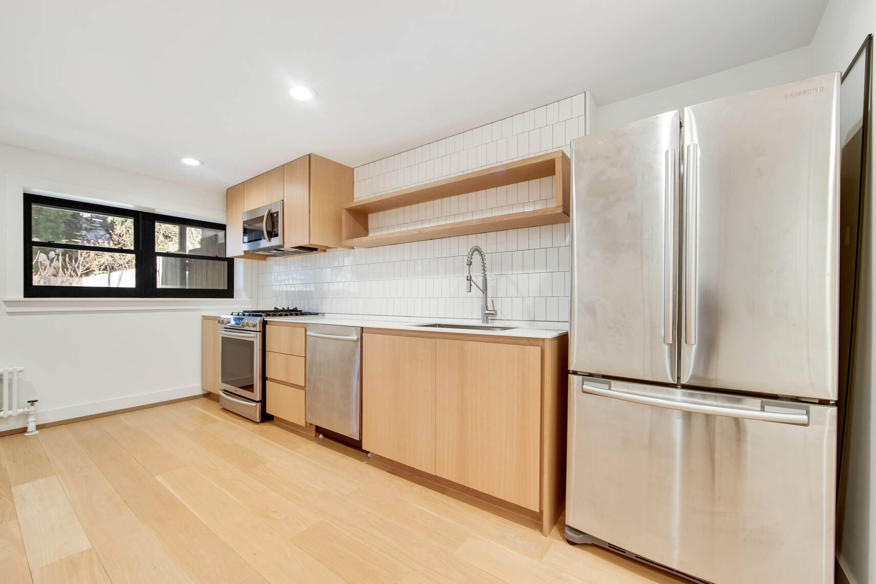a kitchen with white cabinets and white appliances
