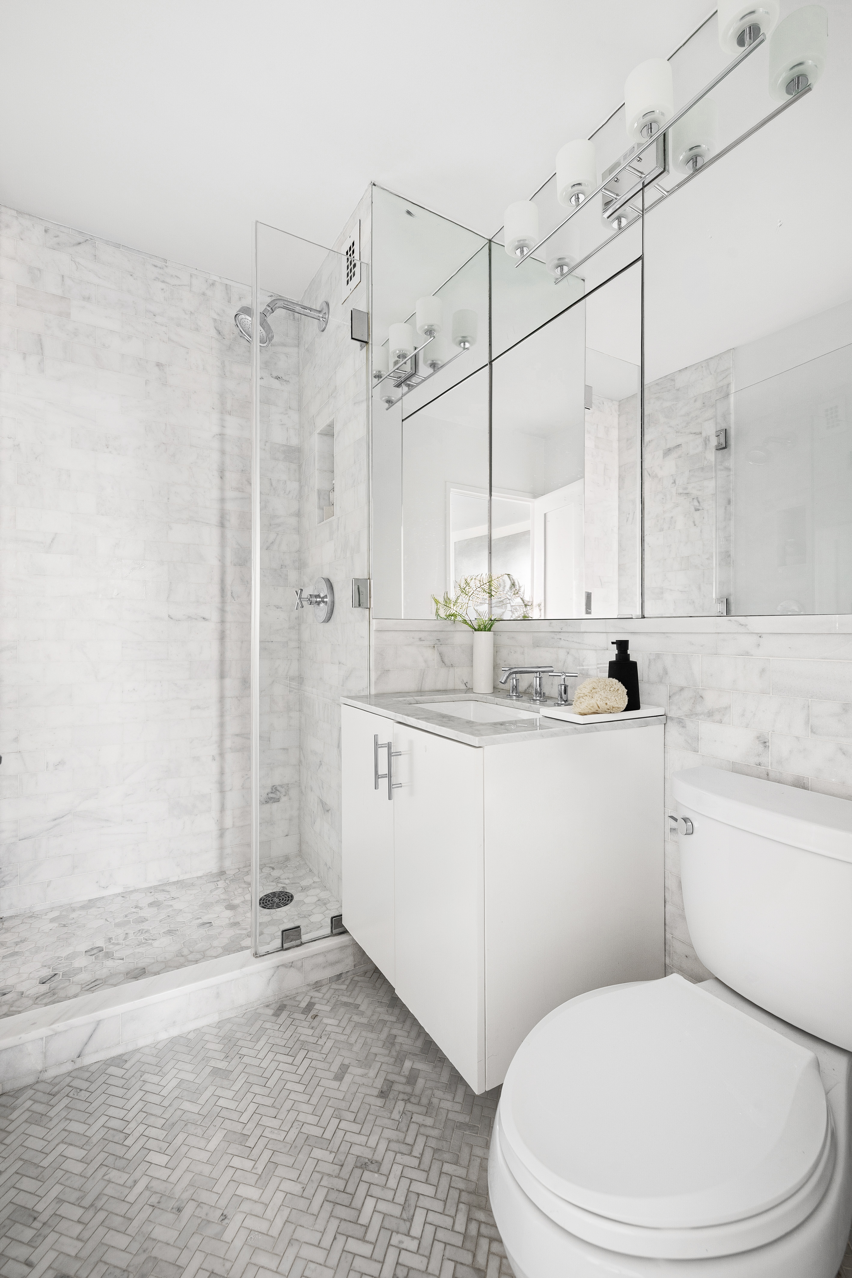 1623 3rd Avenue, Unit 36A Manhattan, NY 10128 - Photo 11 of 17 a bathroom with a granite countertop sink a toilet and shower