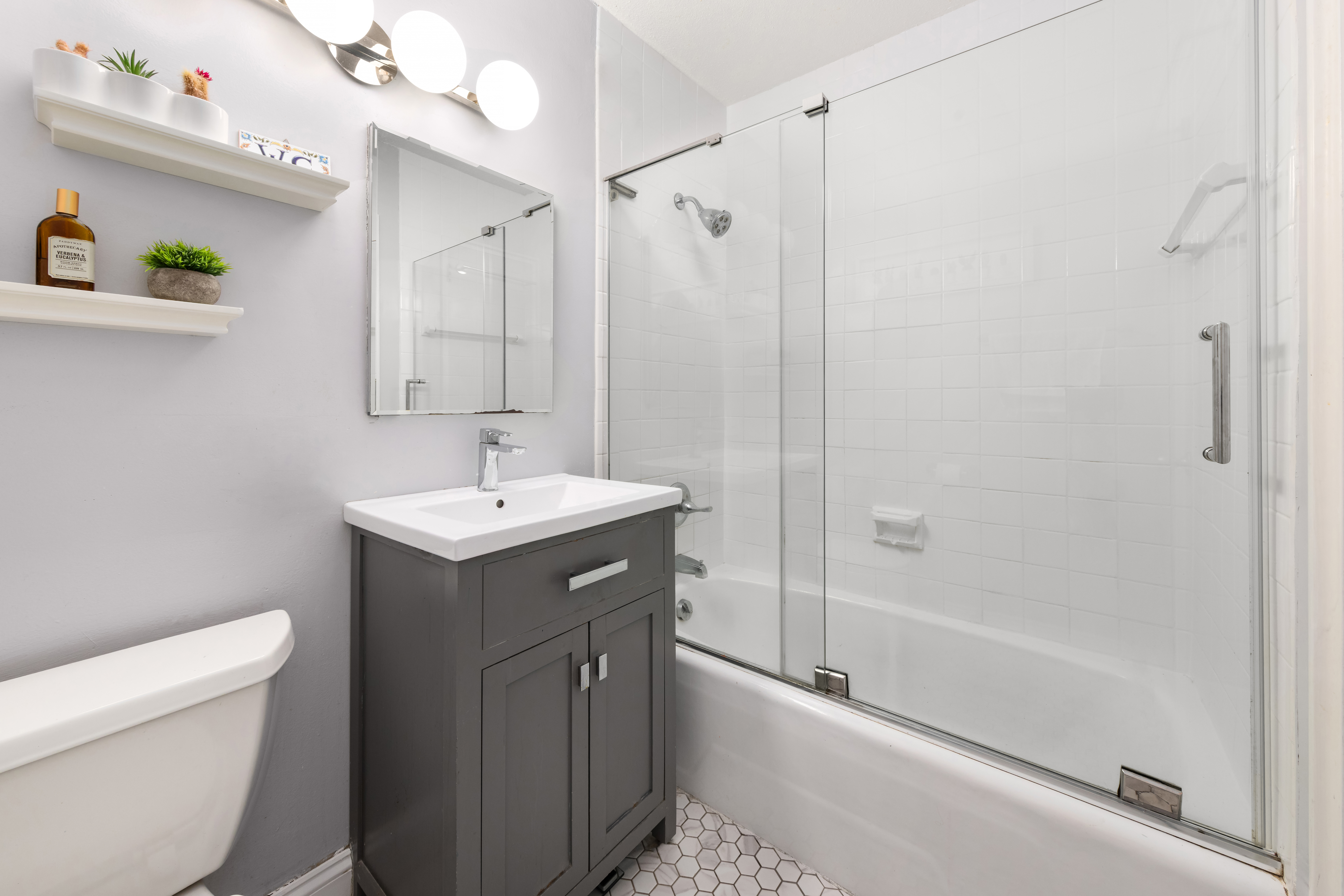 70-31 108th Street, Unit 12D Queens, NY 11375 - Photo 7 of 16 a bathroom with a sink a toilet and shower
