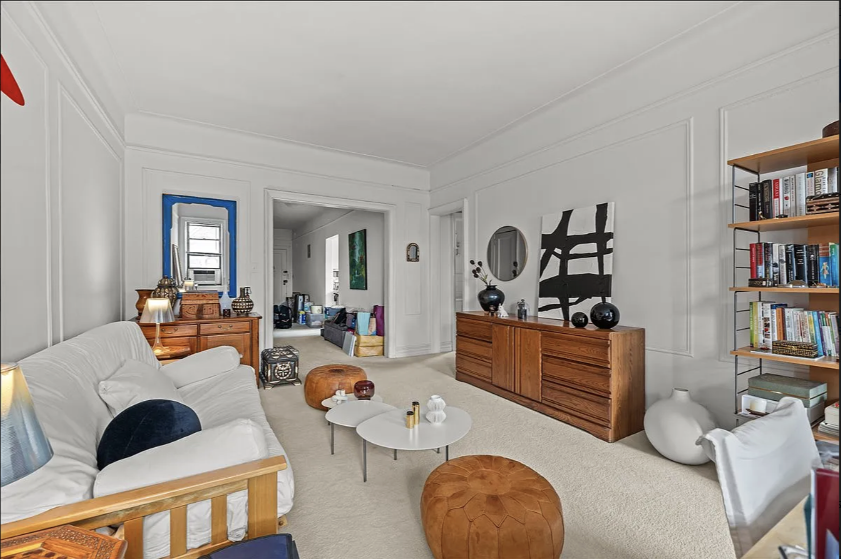 a living room with furniture a book shelf and a book shelf