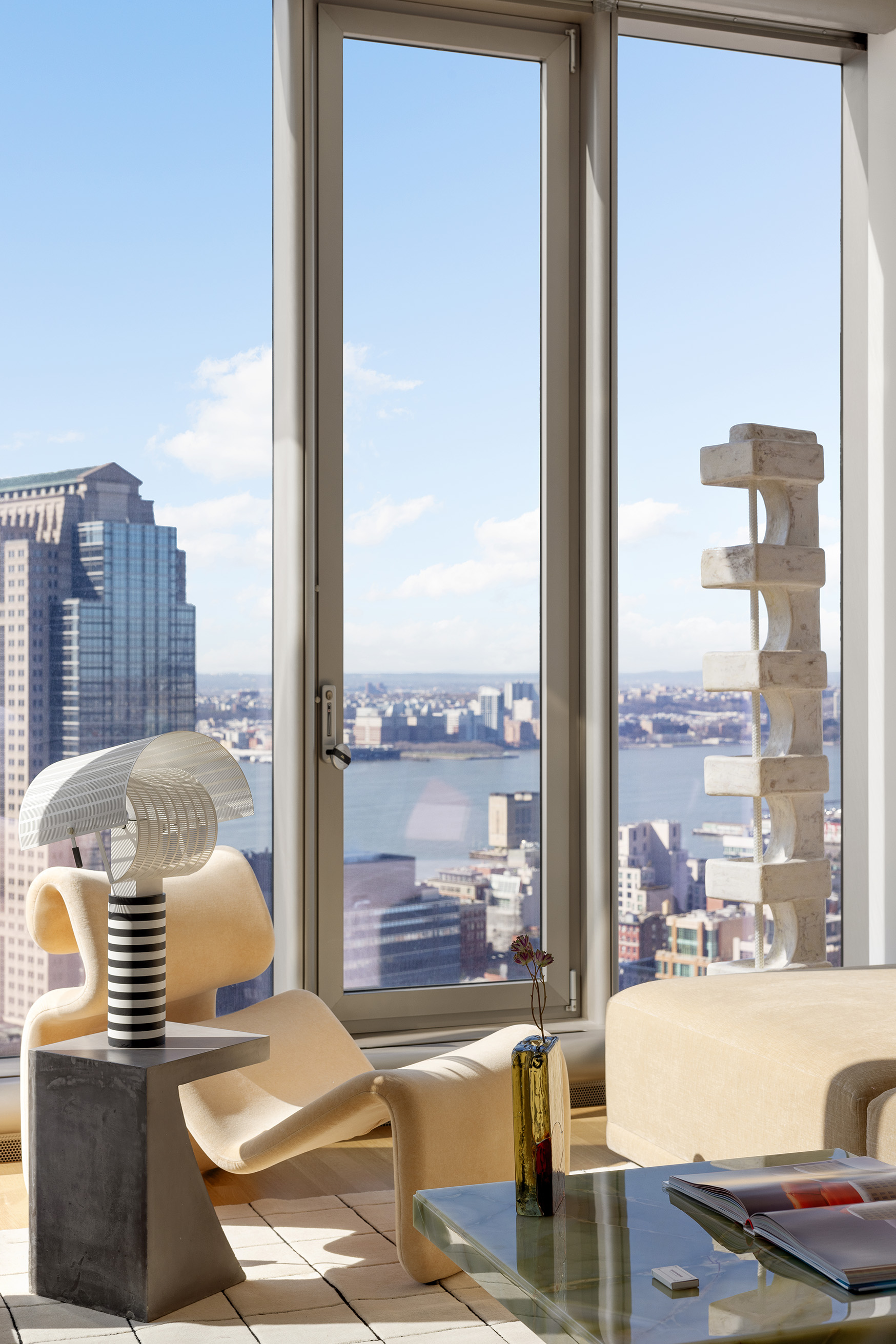 56 Leonard Street, Unit 33AWEST Manhattan, NY 10013 - Photo 4 of 12 a living room with furniture and a floor to ceiling window