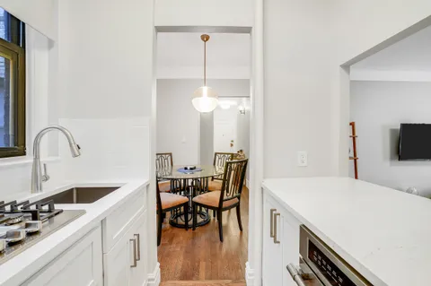 a kitchen with a table chairs and a stove