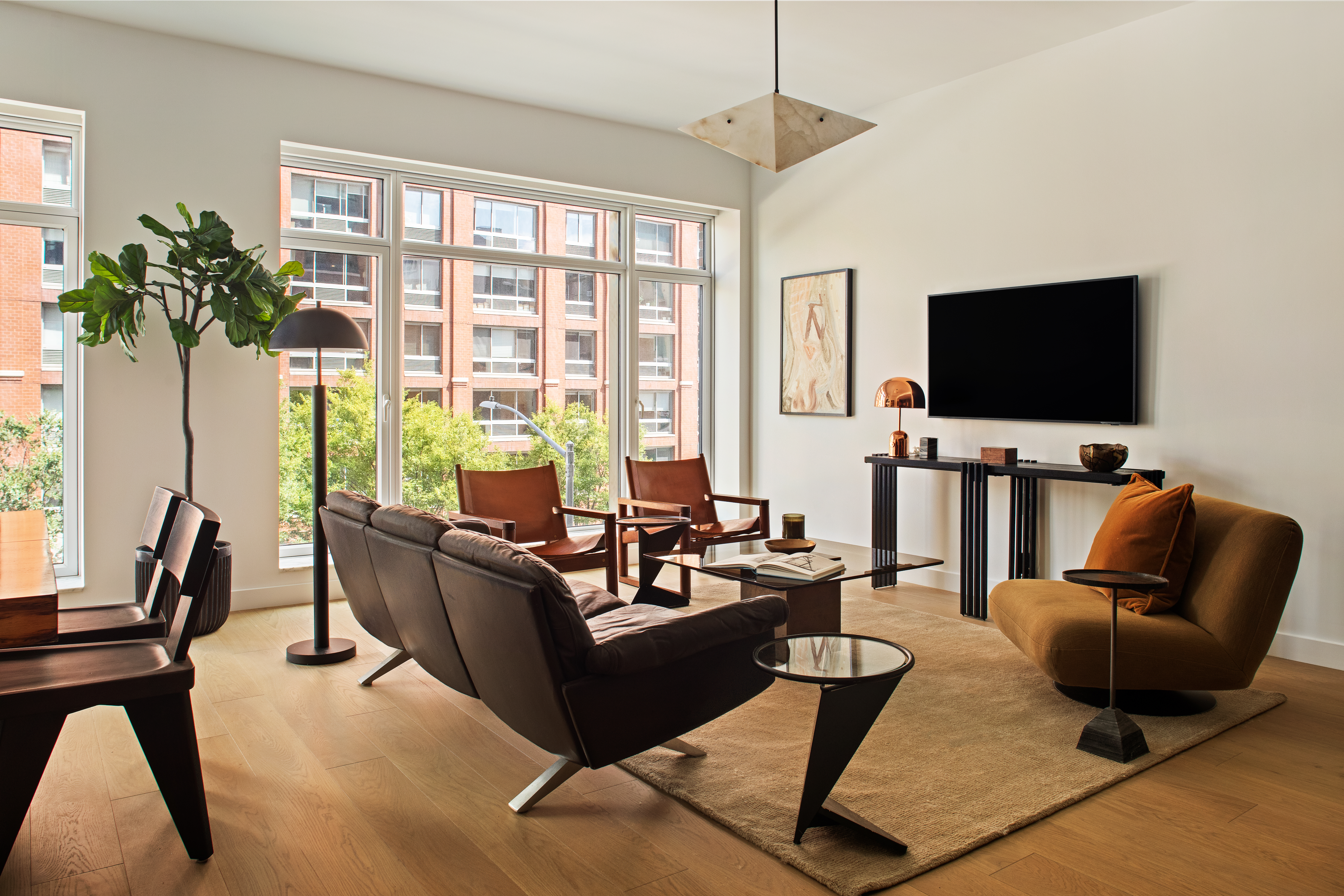 555 West 22nd Street, Unit 4CE Manhattan, NY 10011 - Photo 4 of 21 a living room with furniture a flat screen tv and a large window