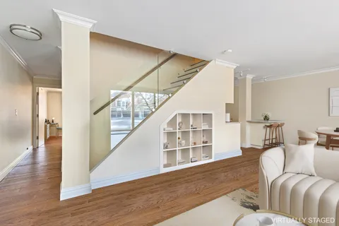 a kitchen with stainless steel appliances kitchen island granite countertop a stove a sink and white cabinets with wooden floor