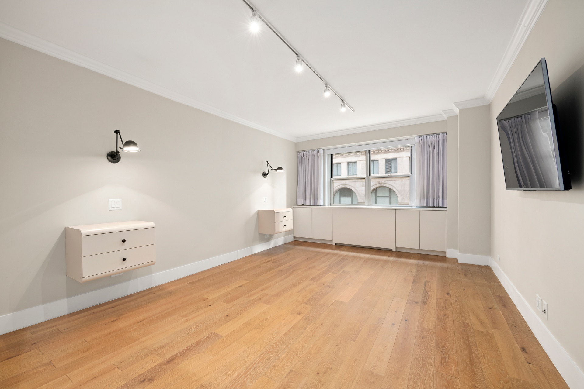 70 East 10th Street, Unit 4V Manhattan, NY 10003 - Photo 16 of 26 wooden floor in an empty room with a window