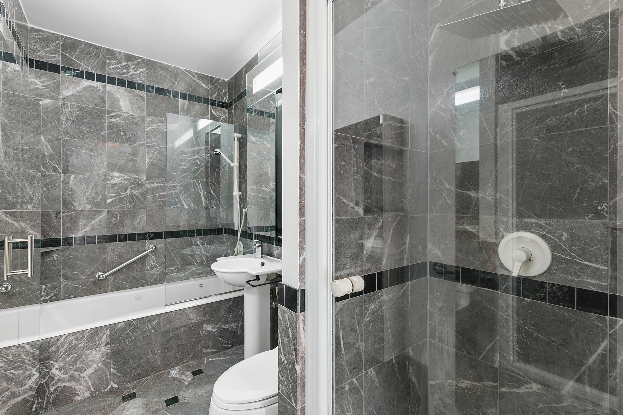 250 East 54th Street, Unit 35A Manhattan, NY 10022 - Photo 4 of 13 a bathroom with a sink and toilet