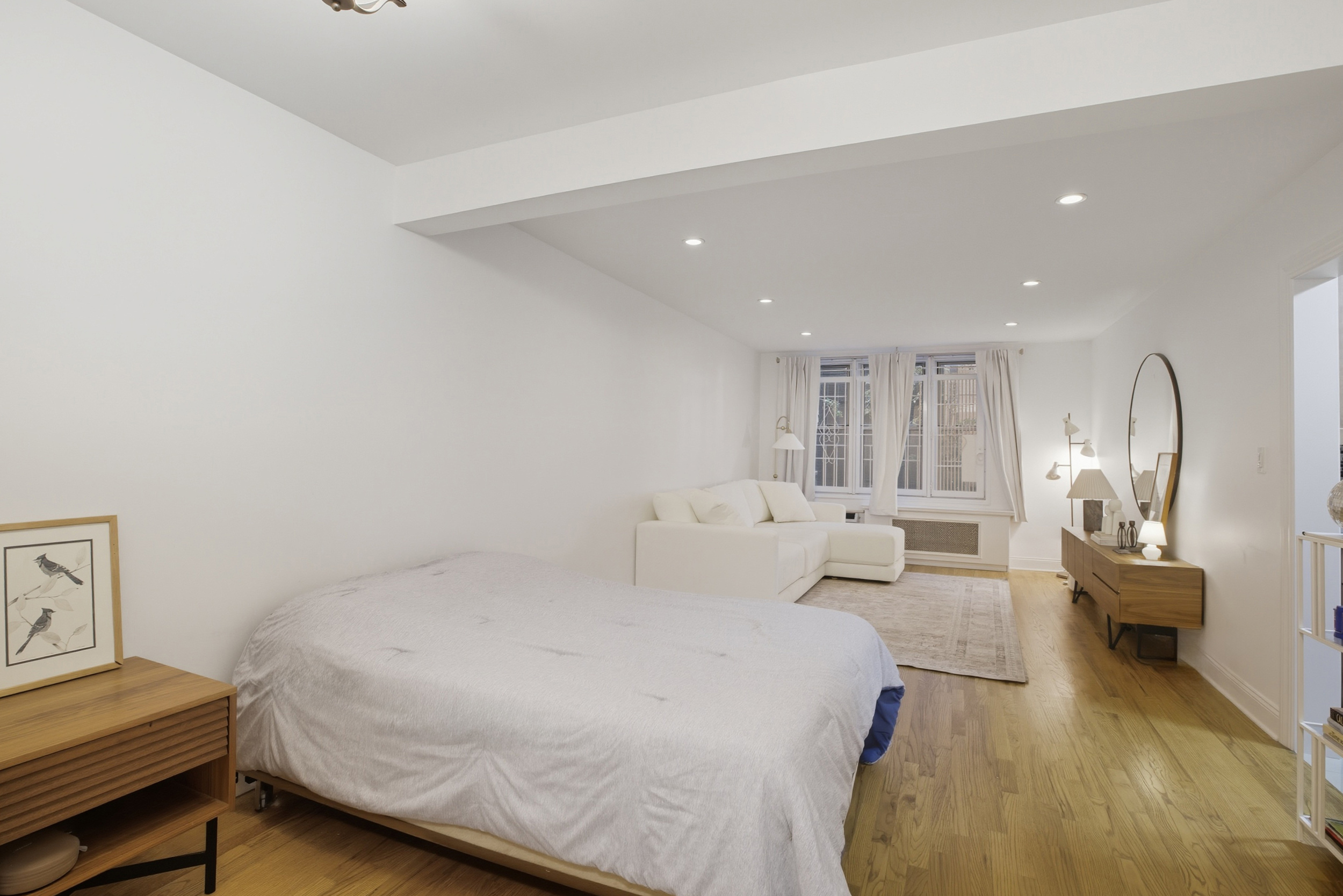 130 Hicks Street, Unit 1E Brooklyn, NY 11201 - Photo 4 of 12 a bed room with a bed window and a mirror