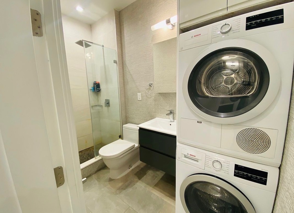 133 East 35th Street, Unit 3 Manhattan, NY 10016 - Photo 12 of 16 a bathroom with a sink and a washer dryer