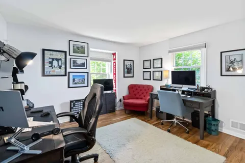 a livingroom with workspace and a couch