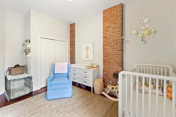 a bedroom with furniture and a window