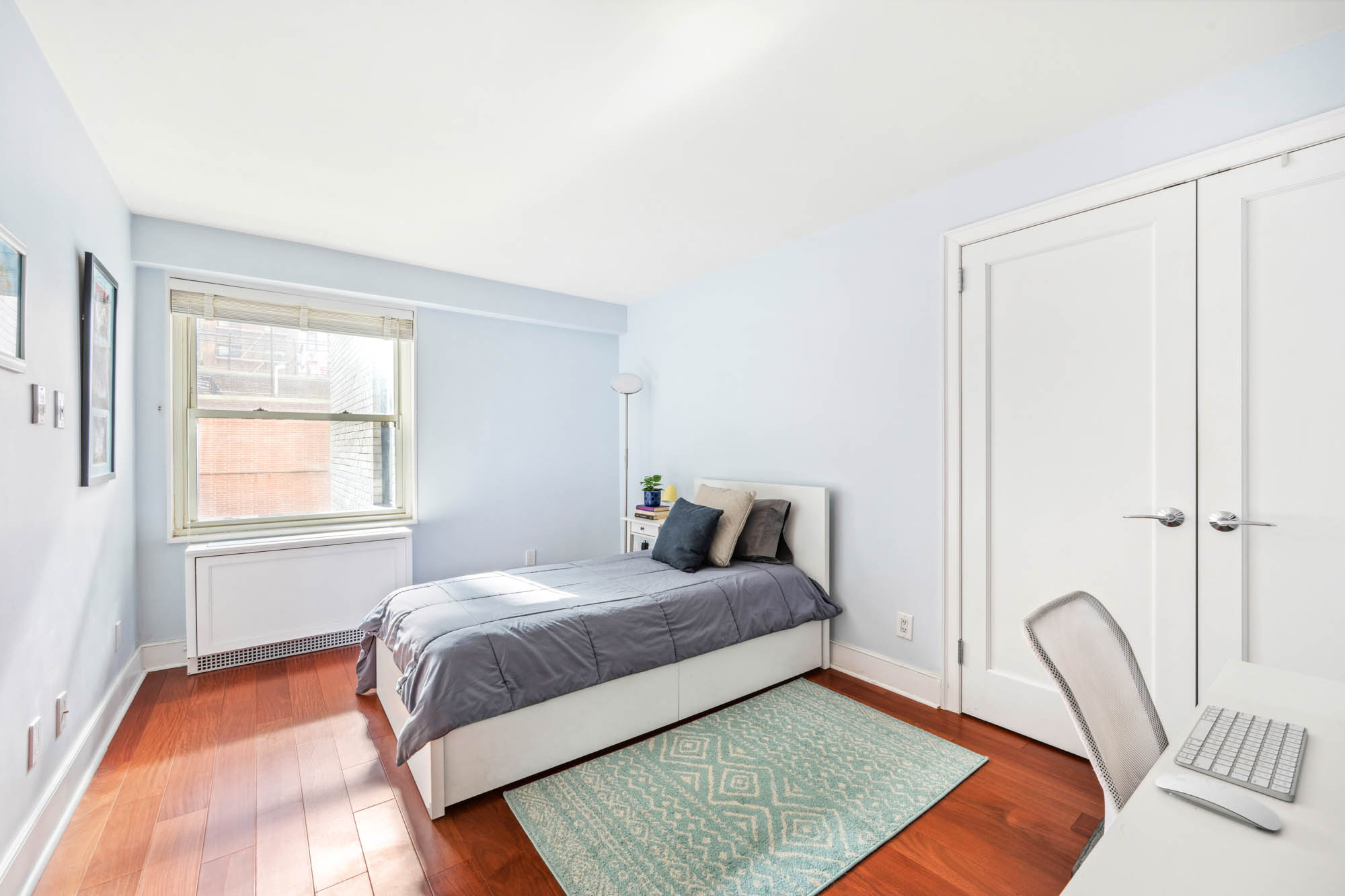 420 East 72nd Street, Unit 2J Manhattan, NY 10021 - Photo 8 of 12 a bedroom with a bed rug and a window