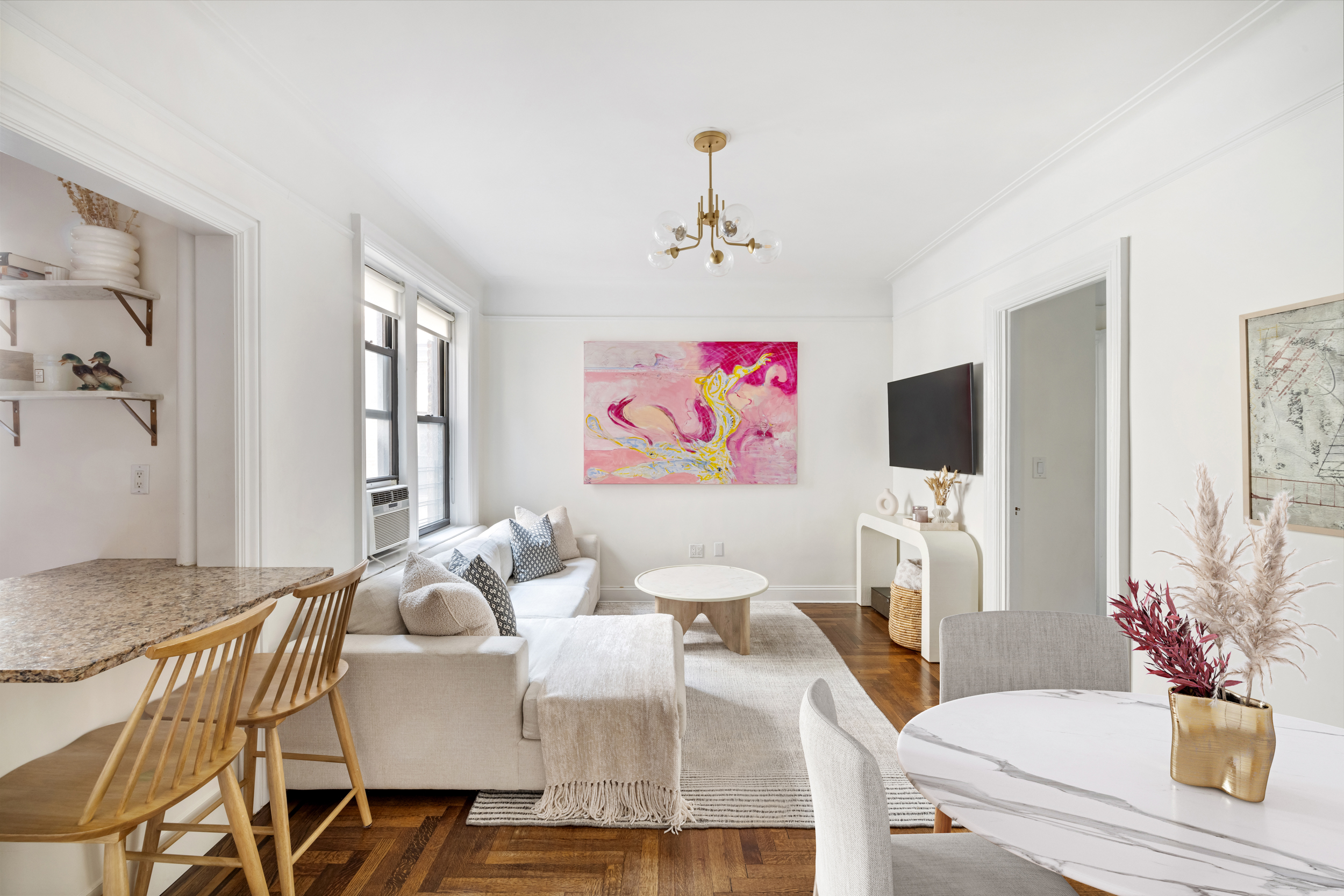 305 East 88th Street, Unit 4A Manhattan, NY 10128 - Photo 12 of 13 a living room with furniture and a flat screen tv